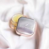 HighOnLove Limited Edition Sensual Lip Balm in a sleek silver tin on soft fabric.