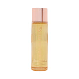 HighOnLove Massage Oil Tropical Sunset in an elegant bottle with a rose gold cap, promoting relaxation and intimacy.
