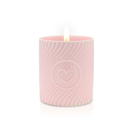 HighOnLove Pink Massage Candle Strawberries & Champagne glowing softly with a flickering flame in a pink decorative container.
