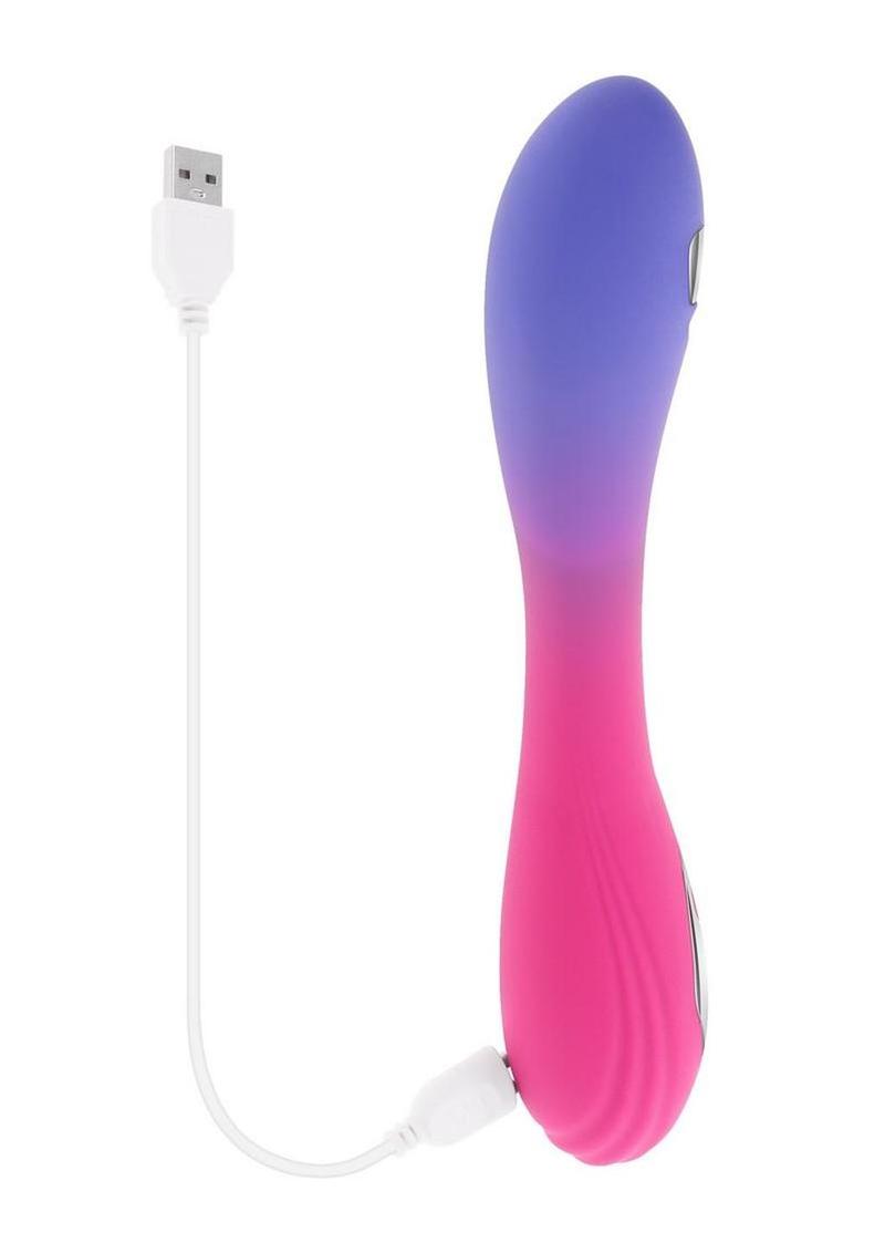 Evolved Paradise Pulse Silicone Vibrator Pink Purple charging with USB cable, showcasing its sleek design.