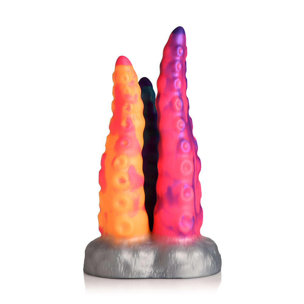Creature Cocks Tentacle Trio Silicone Dildo in vibrant orange, pink, and blue colors with a textured design.