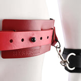 Close-up of Sex & Mischief Exs & Ohs Bound and Belted red faux leather restraint belt with metal clips.
