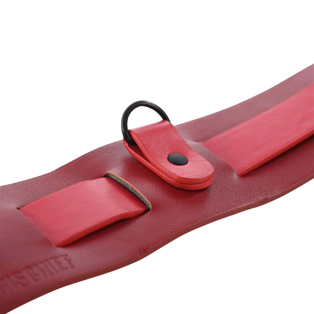 Close-up of the Sex & Mischief Exs & Ohs Bound and Belted restraint belt featuring red faux leather design.