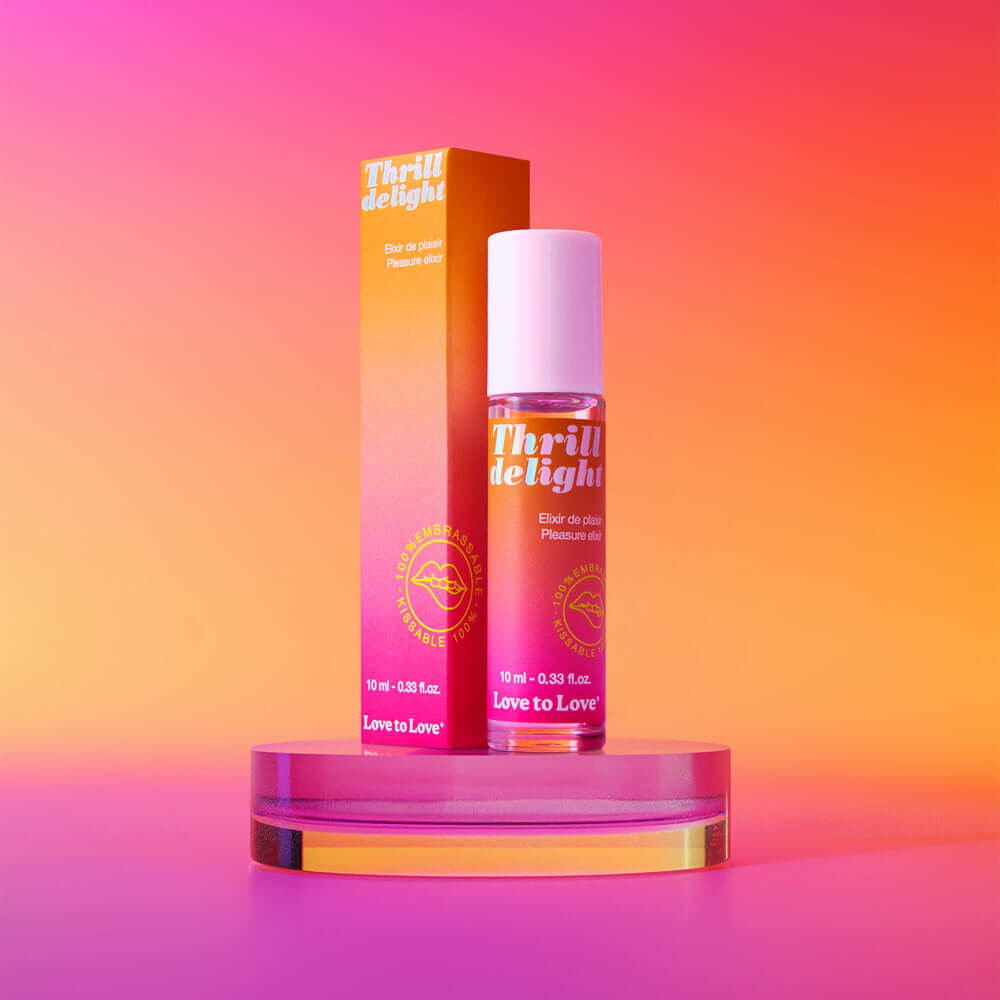 Love to Love Thrill Delight Pleasure Elixir 0.33 Oz with vibrant packaging on a colorful background.