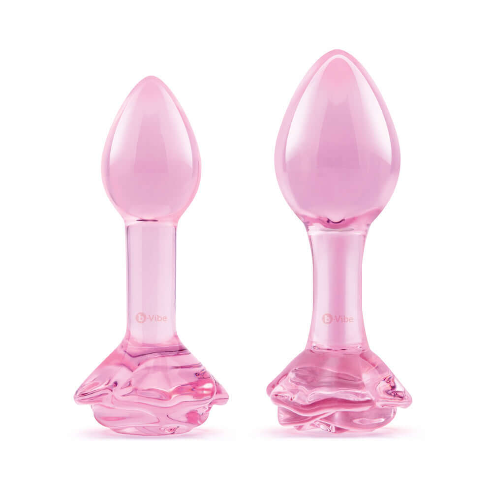 b-Vibe Glass Pink Roses Training Plug Set showcasing two sleek pink glass butt plugs with rose-detailed bases.