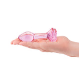 b-Vibe Glass Pink Roses Training Plug Set resting in a hand, showcasing its elegant design and dusty pink color.