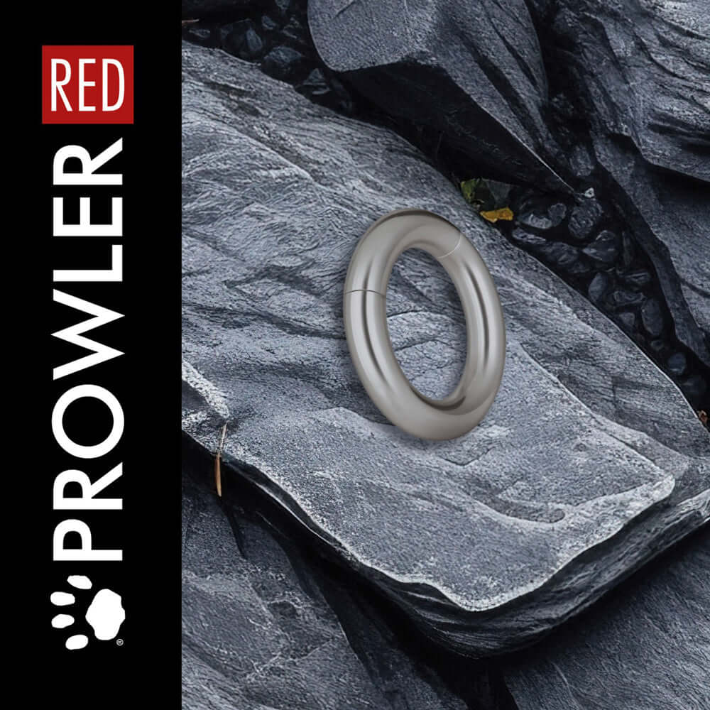 Prowler RED Magnetic 38 mm Cock Ring placed on textured stone background, showcasing its sleek metallic design.