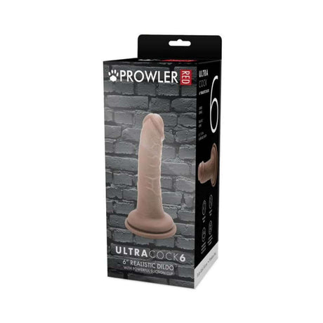 Prowler RED Ultra Cock 6 inch Realistic Dildo Caramel packaging on display against a textured brick background.