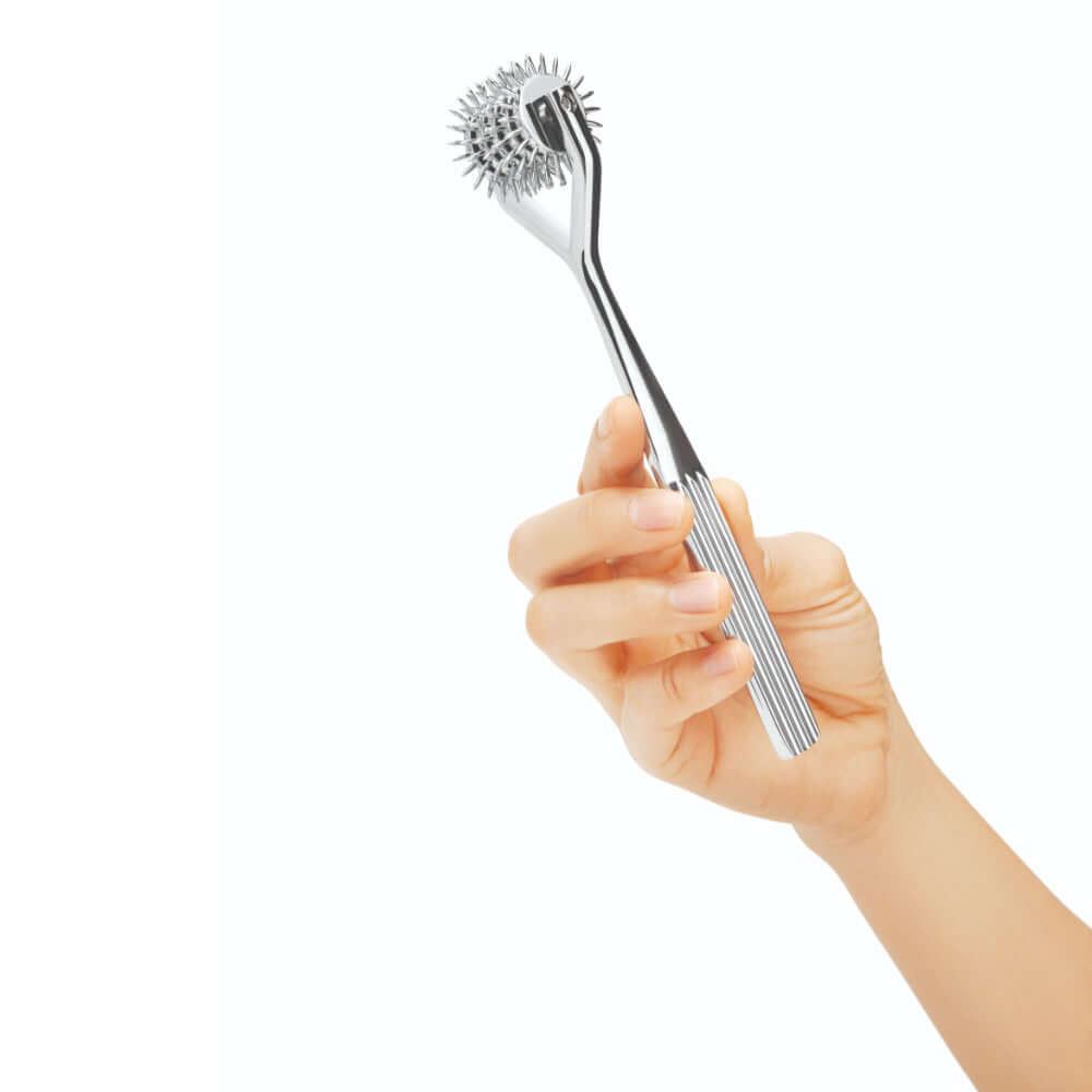 Prowler RED 5 Reel Metal Pinwheel held in a hand, designed for sensory play with five rotating metal wheels.