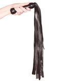 Prowler RED Flogger 26 inches Black held in hand showcasing sleek black design and impact play functionality.