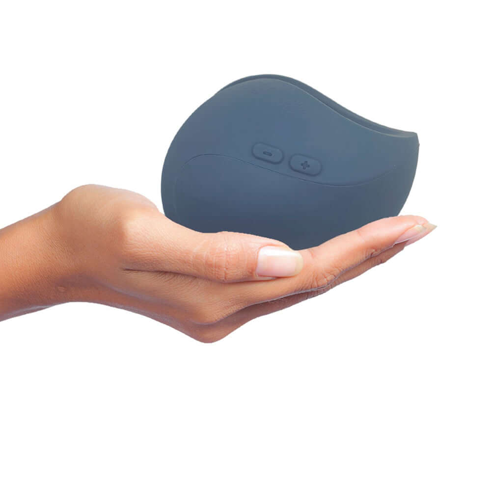 Hand holding the Hot Octopuss Pulse Duo Remote Control Vibrating Stroker Blue showcasing its compact design.