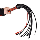 Prowler RED Short Handle Flogger Black Red held in hand showcasing its braided design and flexible tails.