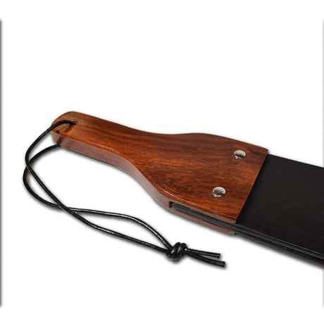 Close-up of the Prowler RED Leather & Wood Flapper Paddle showcasing its wooden handle and leather design.