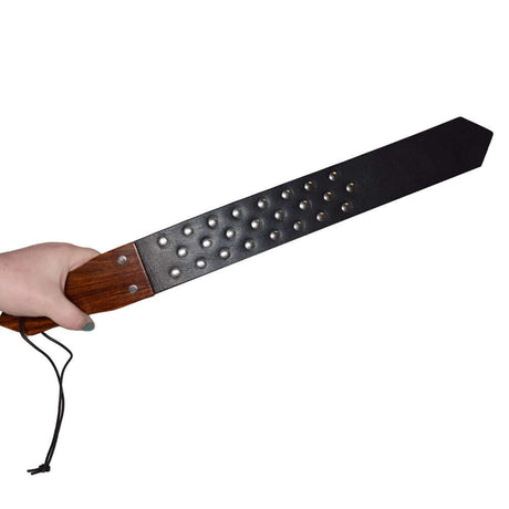 Prowler RED Leather & Wood Studded Paddle showcasing the durable leather and wooden handle design with metal studs.
