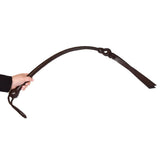 Prowler RED Leather Whip Brown held in hand for impact play showcasing its premium leather quality and craftsmanship.