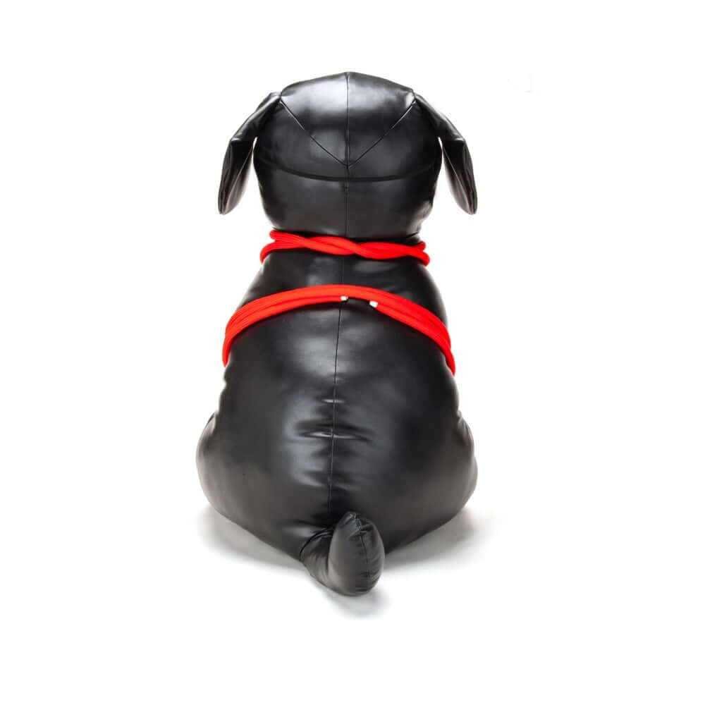 Prowler RED Roped Up Rover L black faux leather harness with red ropes on a dog figure from behind.