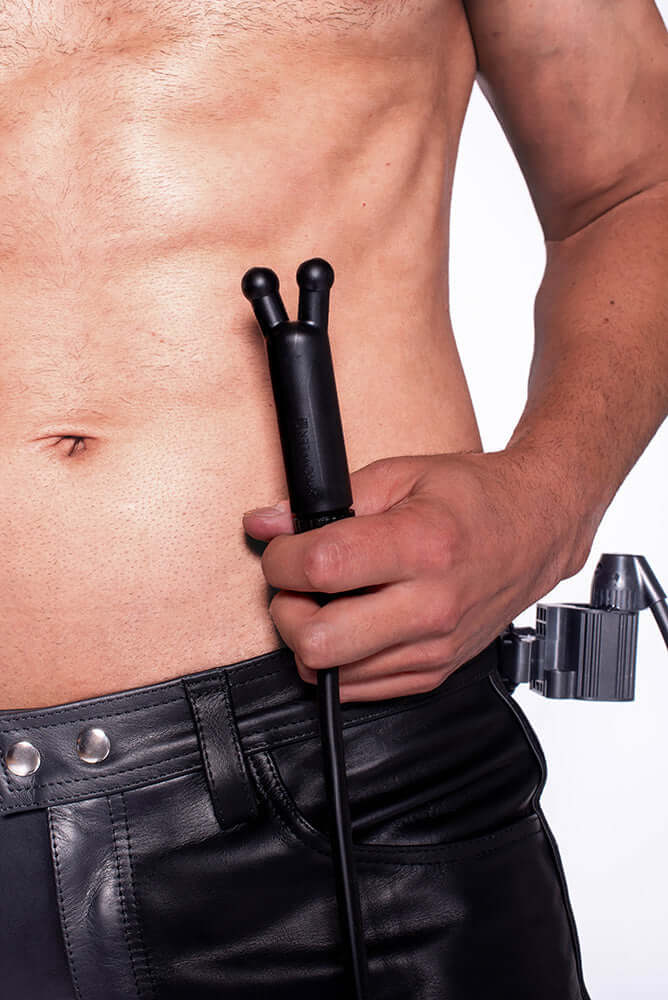 Prowler RED Toppers The Kit Black held by a model in black leather pants, showcasing the versatile accessory for intimate play.