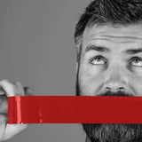 Prowler Bondage Tape Restraints Red 20 m held by a person, showcasing its use in bondage scenarios.