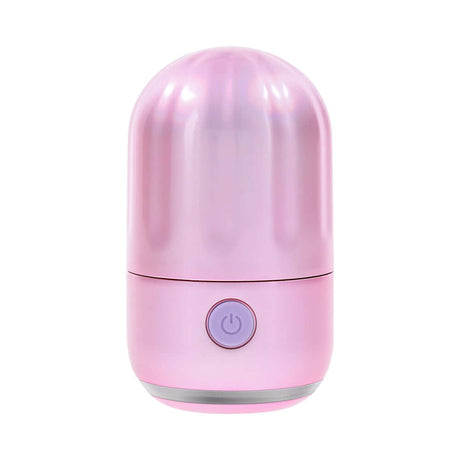 Evolved Vacation Vibes Tapping Massager in a pink-pearl iridescent design, showcasing its compact and stylish canister.