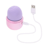 Evolved Vacation Vibes Tapping Massager in pink-pearl iridescent color with USB charger attached.