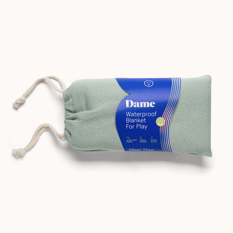 Dame Thro Waterproof Sex Blanket Sage packaged in a soft green bag, ideal for keeping surfaces clean during intimate moments.