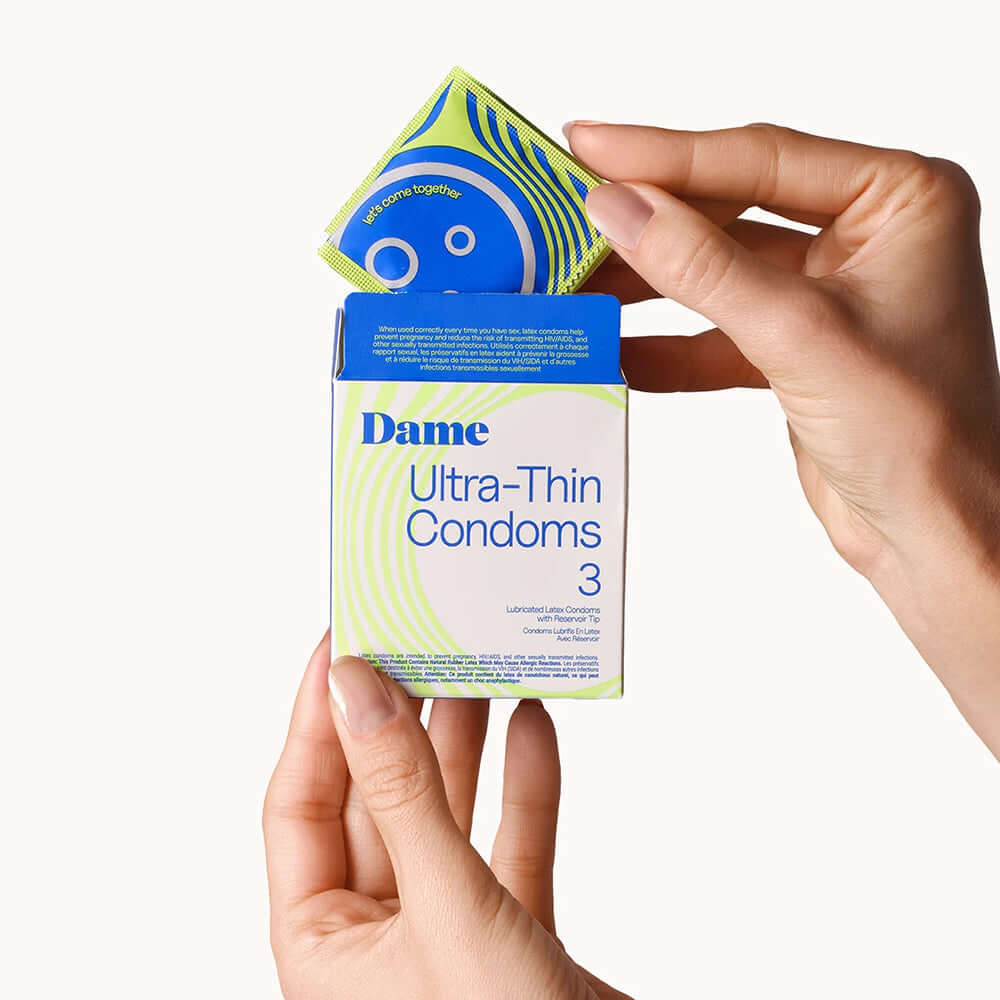 Dame Condoms 3-Pack showing ultra-thin condoms in hand, emphasizing protection and intimacy.