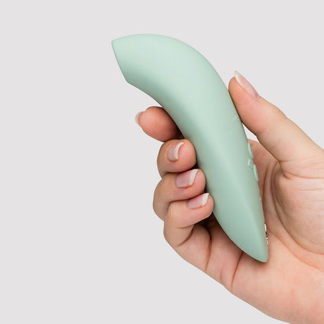 We-Vibe Melt 2 Pleasure Air Clitoral Stimulator Sage held in hand, featuring sleek design for partner-friendly use.