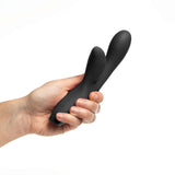 Person holding the Je Joue Hera Flex Dual Rabbit Vibrator, showcasing its sleek design and soft-touch silicone.