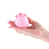 INYA The Vibrating Rose Pink held in a hand, showcasing its elegant rose design and smooth silicone texture.