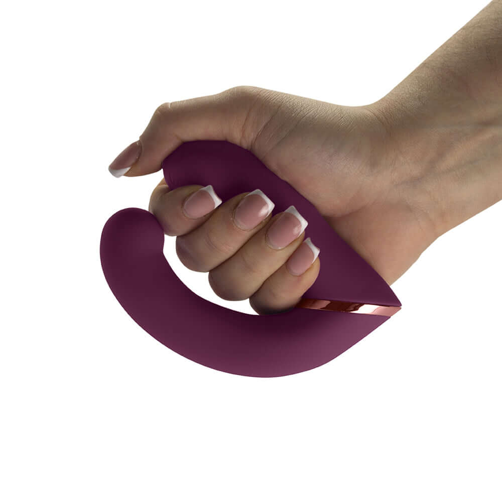 Rocks-Off Gemini Dual Stimulator Burgundy held in hand, showcasing its ergonomic design and luxurious texture.