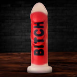 Master Series BITCH Silicone Dildo in bold red with textured surface, designed for intense pleasure and psychological play.