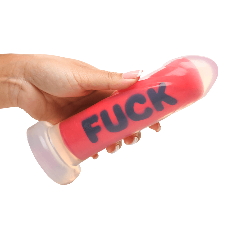 Master Series FUCK Silicone Dildo held in hand, showcasing its vivid color and textured design.
