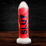 Master Series SLUT Silicone Dildo in red and white, showcasing the bold design and premium quality.