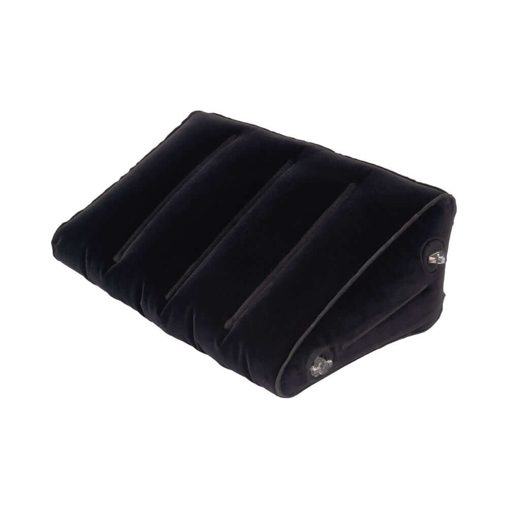 Lux Fetish Inflatable Position Wedge with Detachable Cuffs on a black velvet surface for enhanced comfort and support.