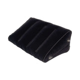 Lux Fetish Inflatable Position Wedge with Detachable Cuffs on a black velvet surface for enhanced comfort and support.