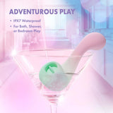 Play With Me Massager Melody Pink in a martini glass, showcasing IPX7 waterproof for adventurous play.