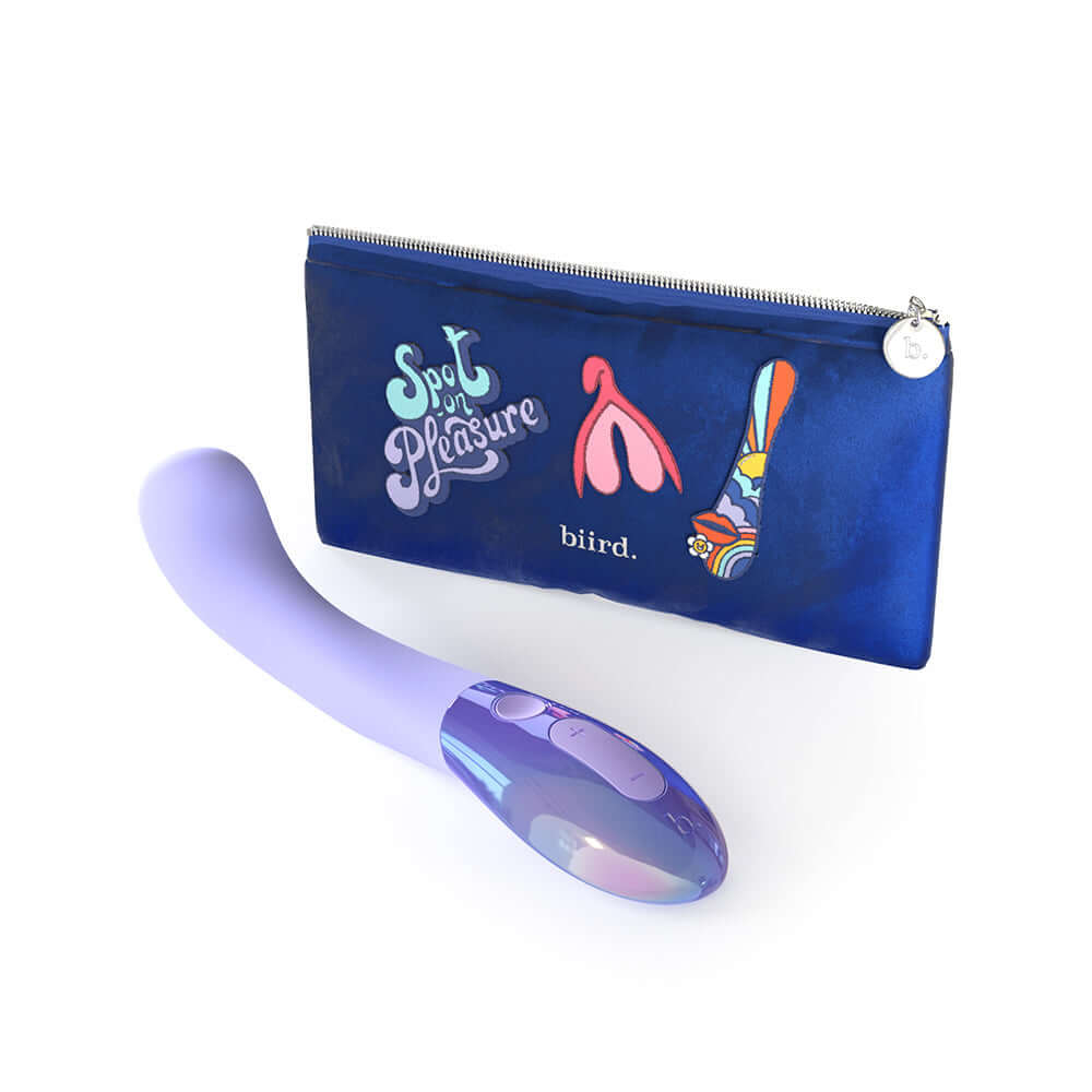Biird Gii Glow Massager Lilac next to a colorful carrying case with playful design.