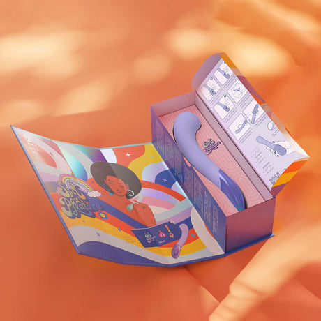 Biird Gii Glow Massager Lilac in colorful packaging displayed on an orange background.