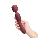Le Wand Flat Top Fusion G Double-Ended Petite Wand Vibrator held in hand, featuring a rounded tip for targeted pleasure.