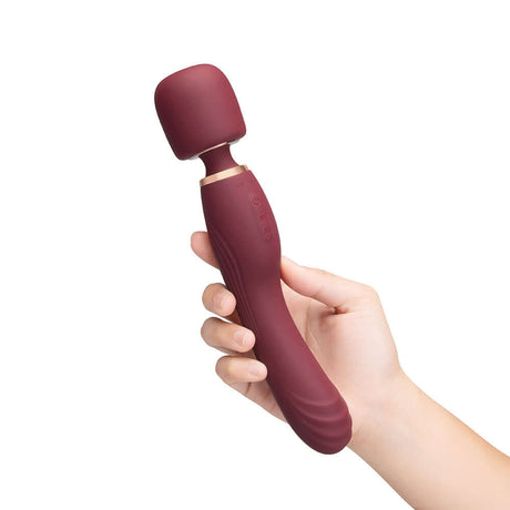 Le Wand Flat Top Fusion G Double-Ended Petite Wand Vibrator held in hand, featuring a rounded tip for targeted pleasure.