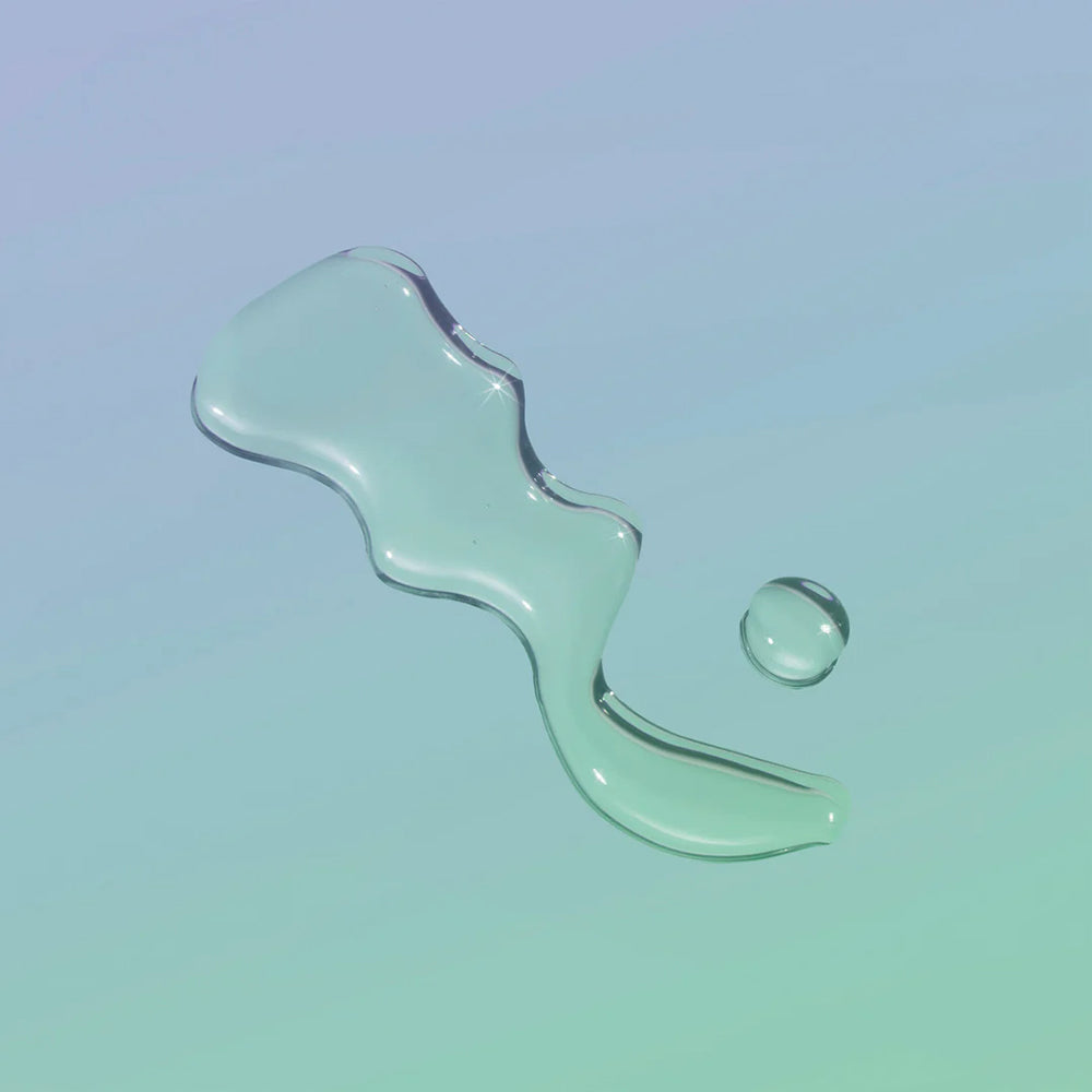 Playground Free Love Water-Based Personal Lubricant 3.7 Oz, clear lubricant droplet on light background.