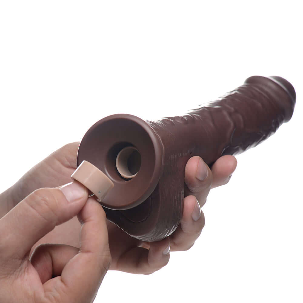 Loadz 8.5 inch Vibrating Squirting Dildo Dark showing battery insertion for enhanced pleasure.