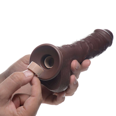 Loadz 8.5 inch Vibrating Squirting Dildo Dark showing battery insertion for enhanced pleasure.