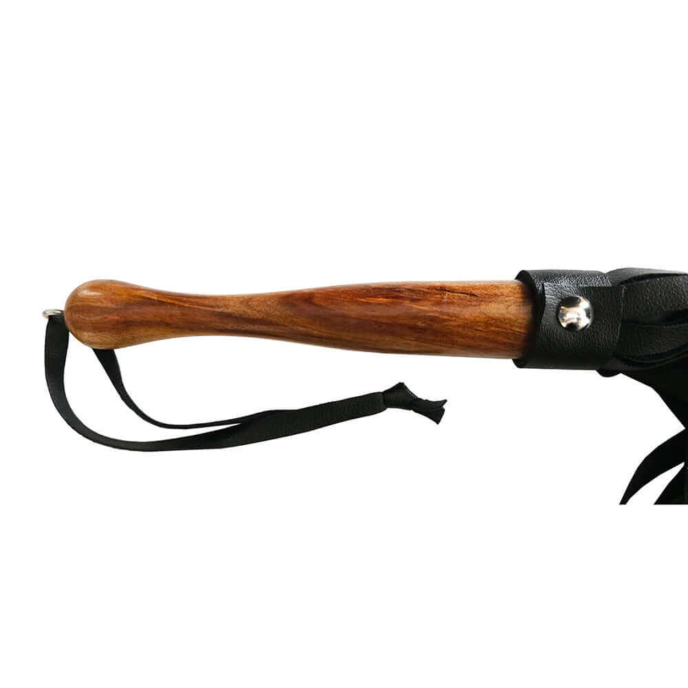 Rouge Fetish Play Vegan Wooden Handle Flogger Black with a sturdy wooden handle and black faux leather tails.