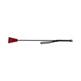 Rouge Fetish Play Vegan Riding Crop Red resting on a flat surface, showcasing its sleek design and sturdy construction.