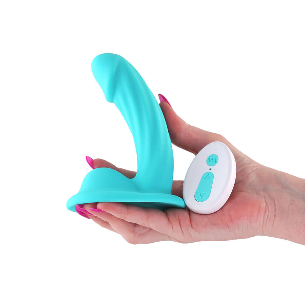 Colours Curve Vibrating 5 inch Dildo Teal held in hand with control button.