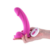 Colours Curve Vibrating 6 inches Dildo Pink held in hand with remote control for easy use.