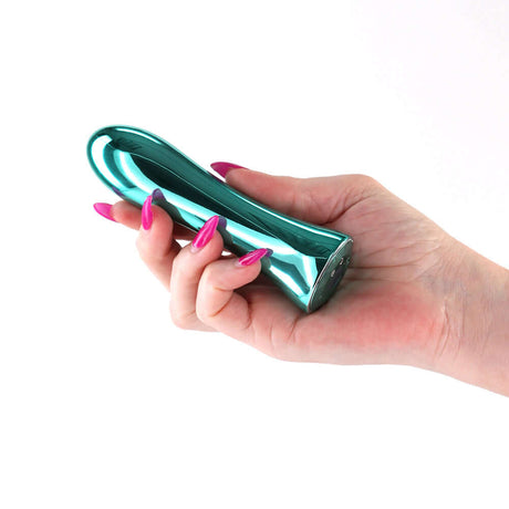Hand holding the INYA Shimmer Metallic Vibrator Aqua with a sleek metallic finish and vibrant design.
