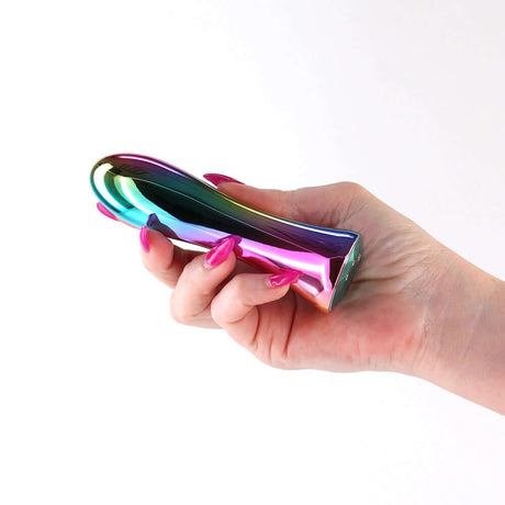 Hand holding the INYA Shimmer Metallic Vibrator Multicolor showcasing its sleek design and vibrant metallic finish.