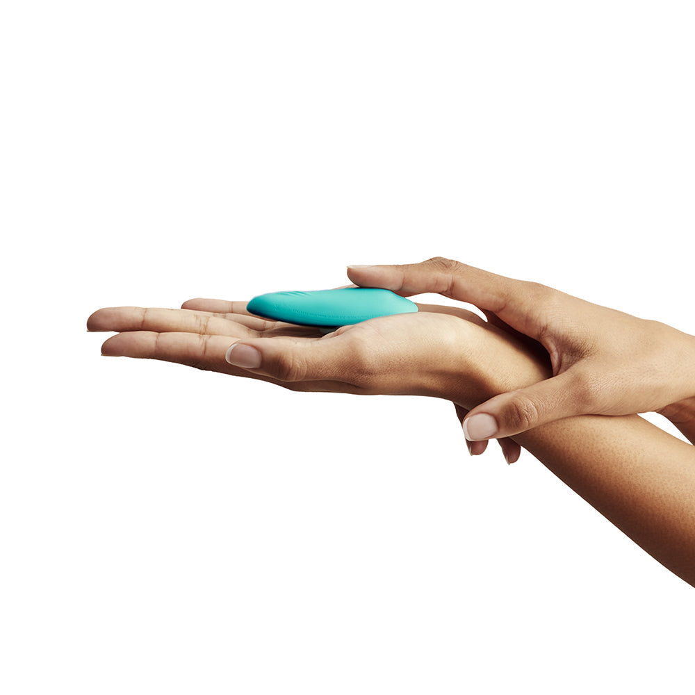 We-Vibe Moxie Plus Wearable Clitoral Vibrator Teal held in a hand, showcasing its compact and discreet design.